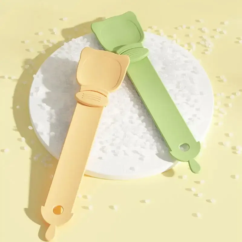 Cat Treat Spoon in green, orange, and white, measuring 27 x 6.5 cm, designed for scooping and serving cat strips