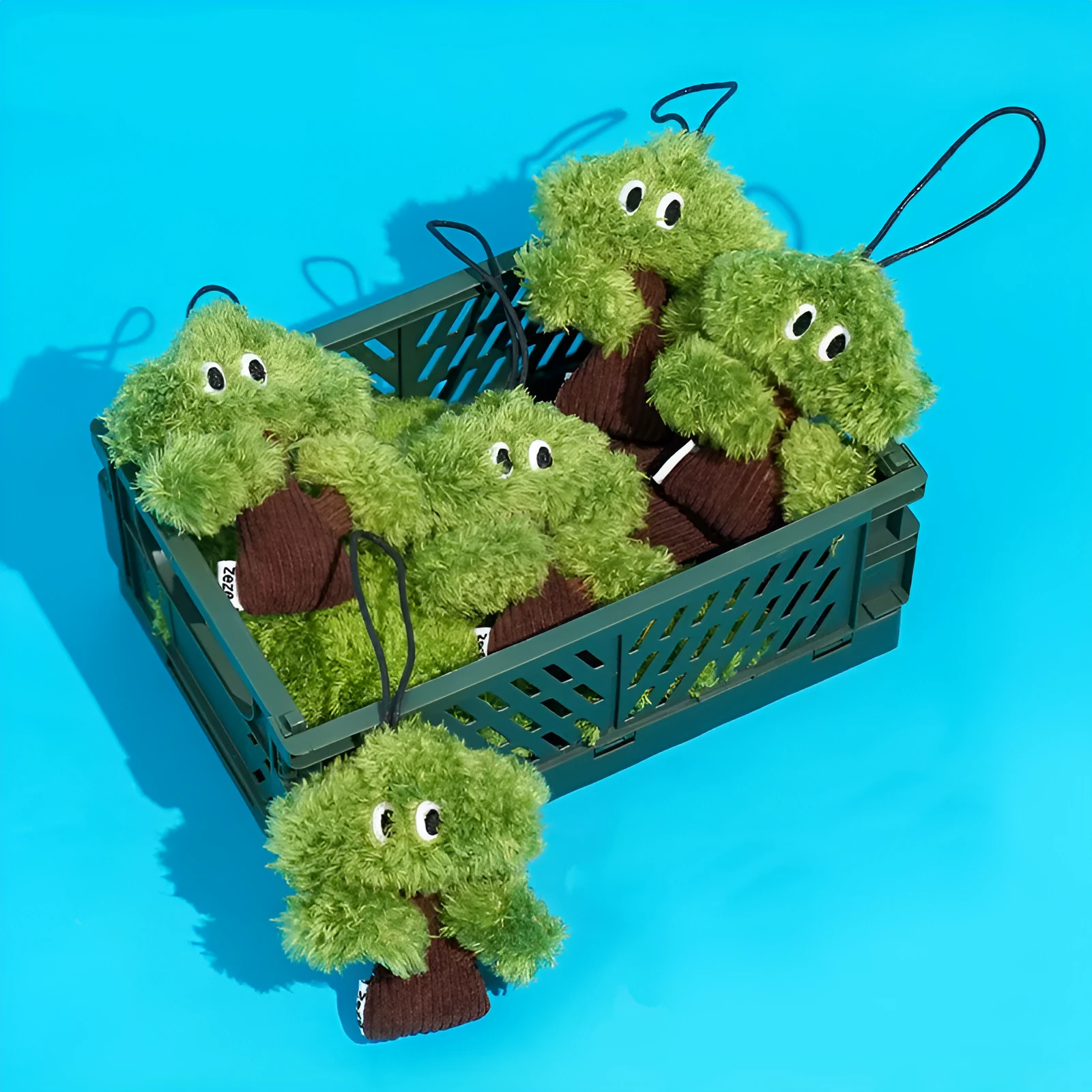 Pine tree shaped fabric cat toy pendant with catnip, shown in three sizes.