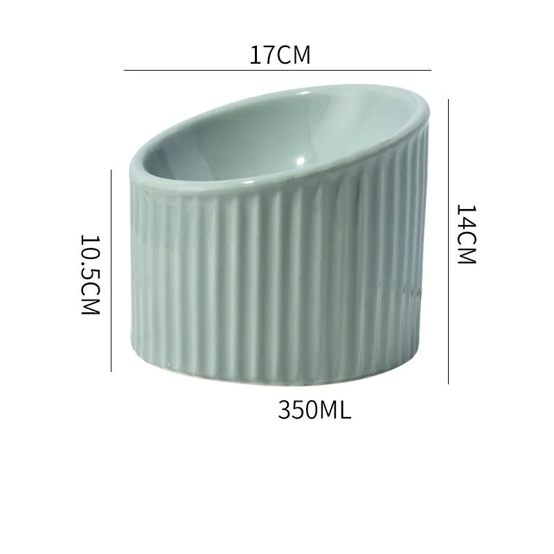 Dark green ceramic elevated cat bowl with tilted, round design on a wooden floor.