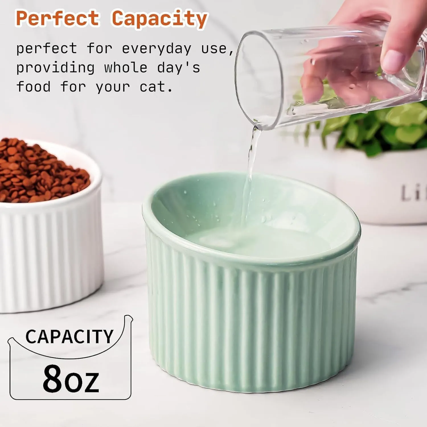 Dark green ceramic elevated cat bowl with tilted, round design on a wooden floor.