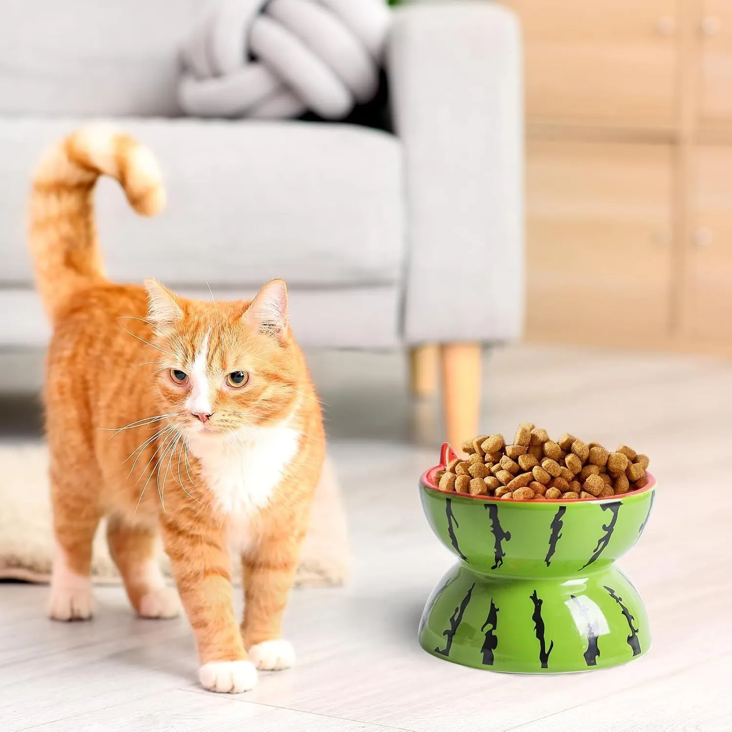 Orange patterned ceramic raised cat bowl on a tilted stand for food and water.