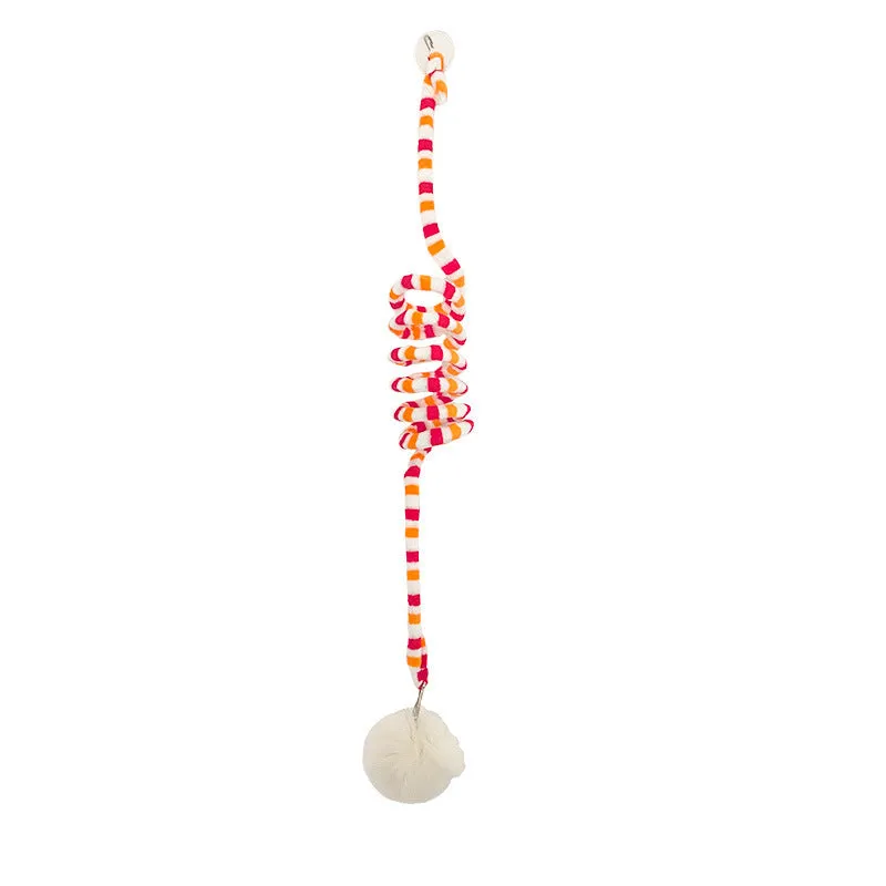 Spring-mounted inflatable ball cat toy with bell, attached to a door via a clear suction cup.