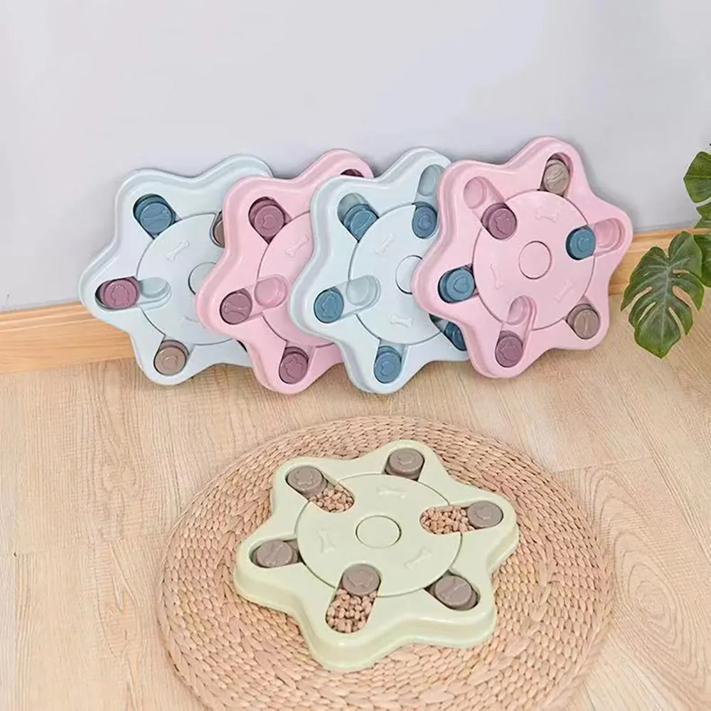 Educational dog toys anti choke dog bowl in pink plastic with non-slip bottom on a wooden floor