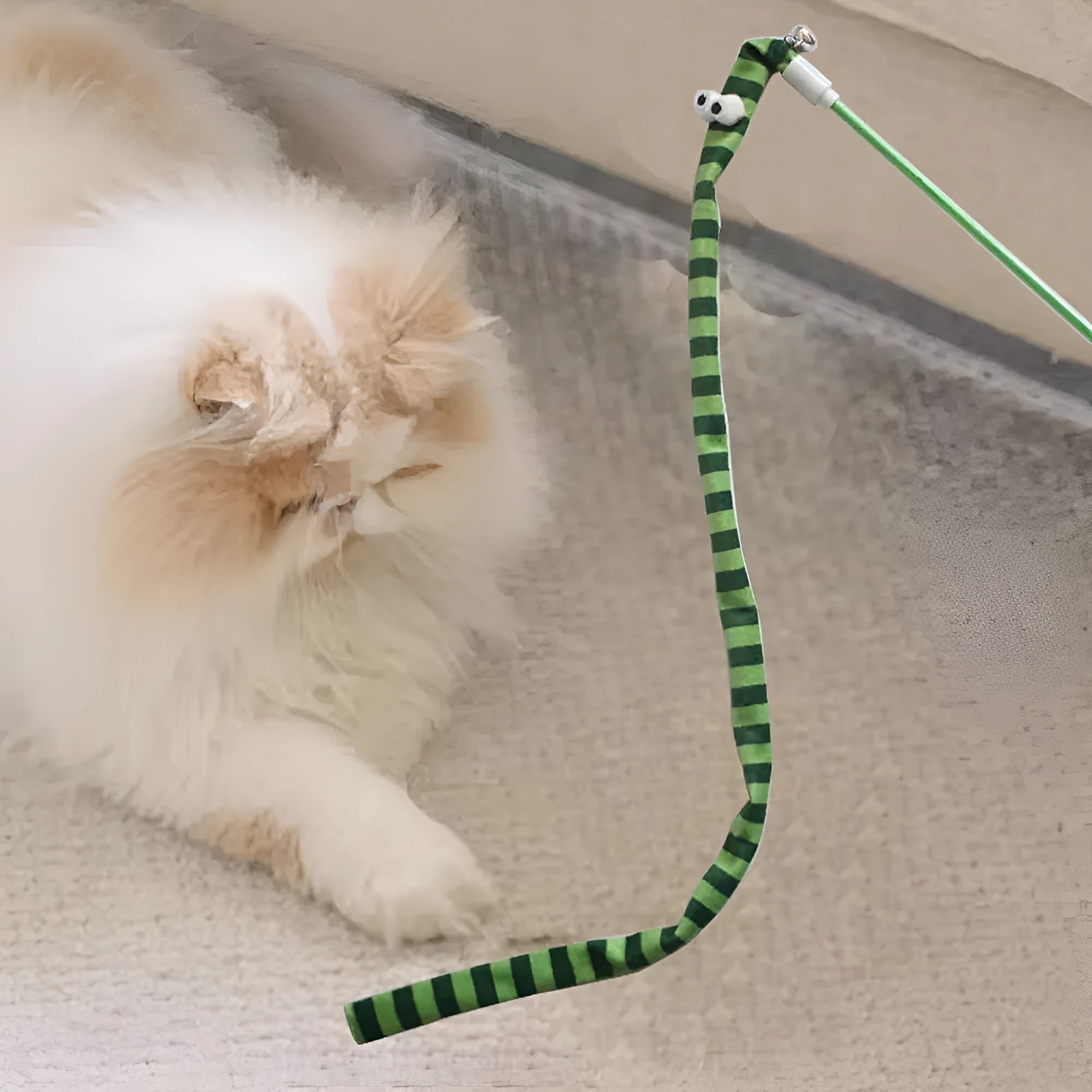 Cat wand teaser toy with a polycarbonate handle and a long green plush strip with a bell.