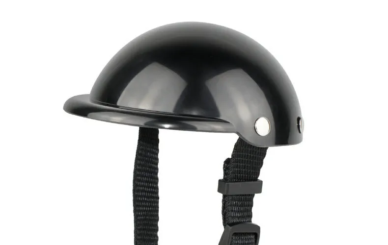 Black pet motorcycle helmet for dog or cat with adjustable strap on a bicycle