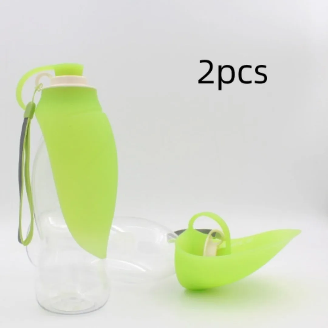 Portable pet water dispenser with black body and flip-up silicone cup next to a dog