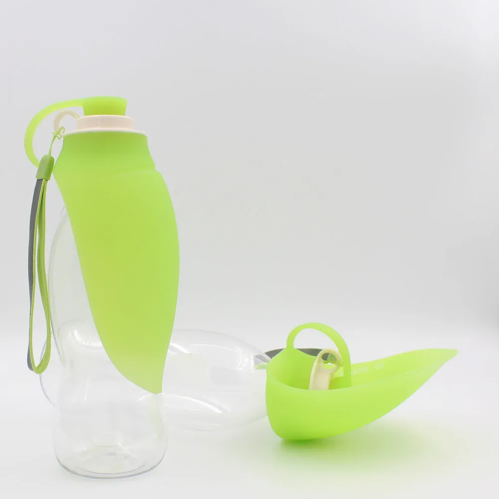 Portable pet water dispenser with black body and flip-up silicone cup next to a dog
