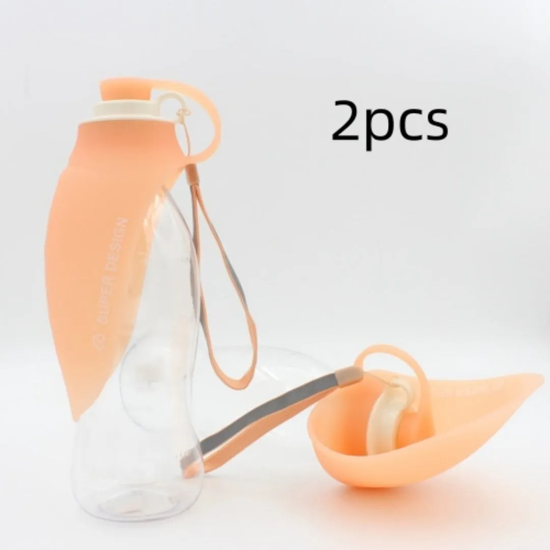 Portable pet water dispenser with black body and flip-up silicone cup next to a dog