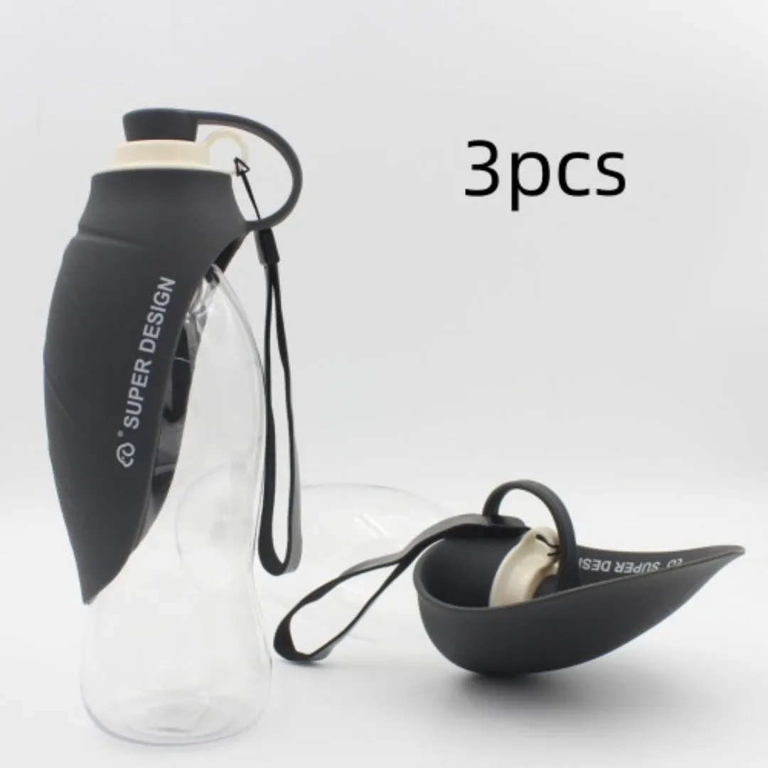 Portable pet water dispenser with black body and flip-up silicone cup next to a dog