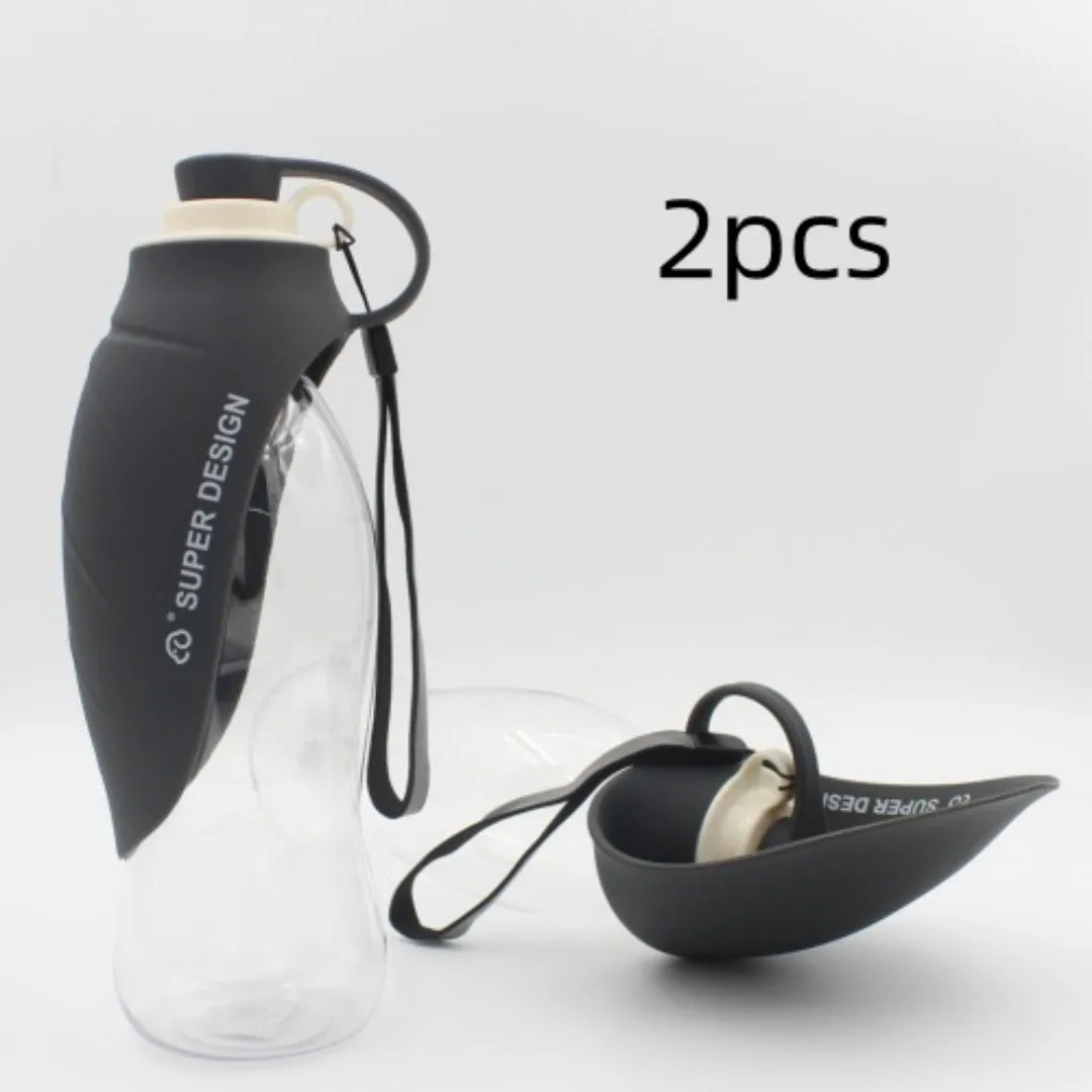 Portable pet water dispenser with black body and flip-up silicone cup next to a dog