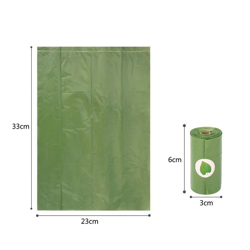 A roll of green EPI degradable pet waste bags next to a black dispenser on a grass background.