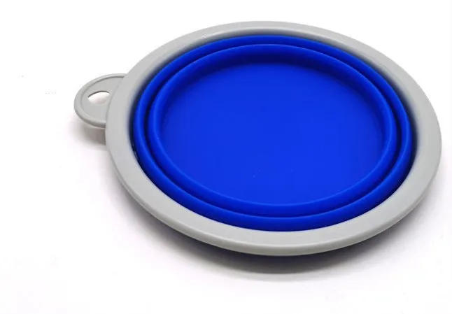 Blue retractable dog leash with ergonomic handle and silicone folding bowl on grass