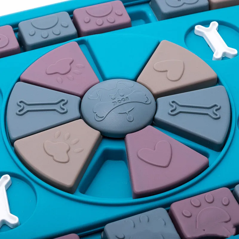 Blue plastic interactive dog food dispenser with sliding panel and locking handles on floor