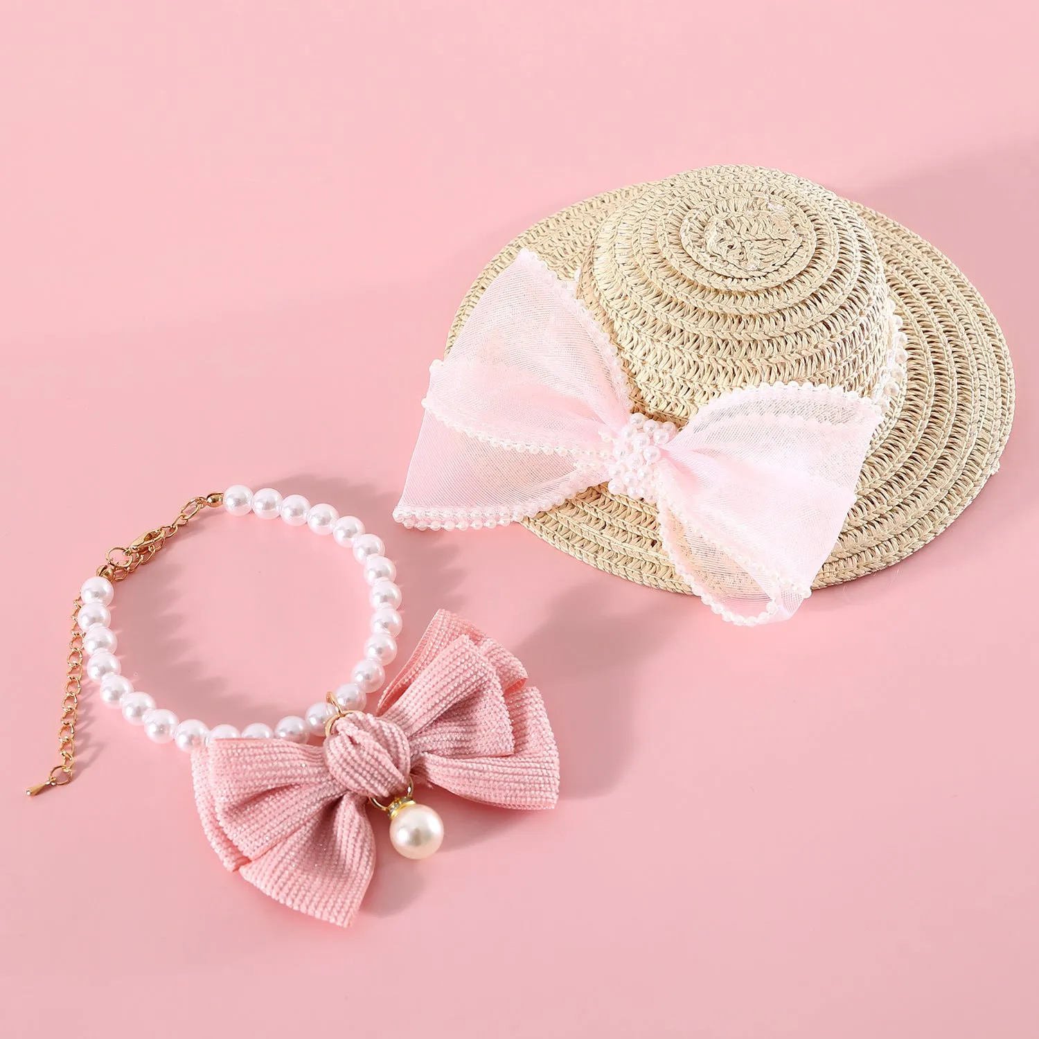 Woven straw cat hat with a pearl bow, shown in blue, pink, purple, and white colour options