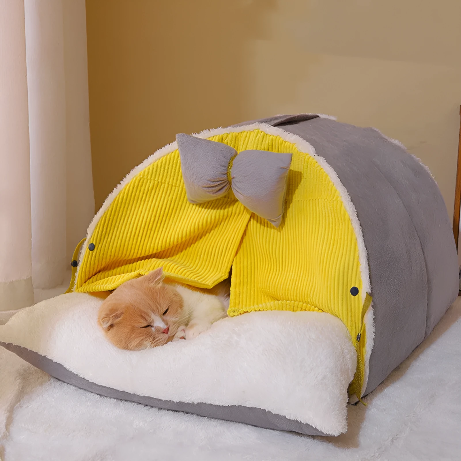 Semi-enclosed cat nest in creamy yellow cloth with grey mat, suitable for all-season indoor use