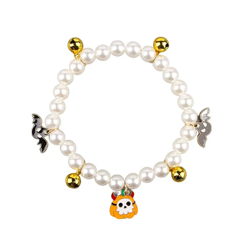 Halloween pet collar with simulated pearls and a purple ghost pumpkin charm around a cat's neck.