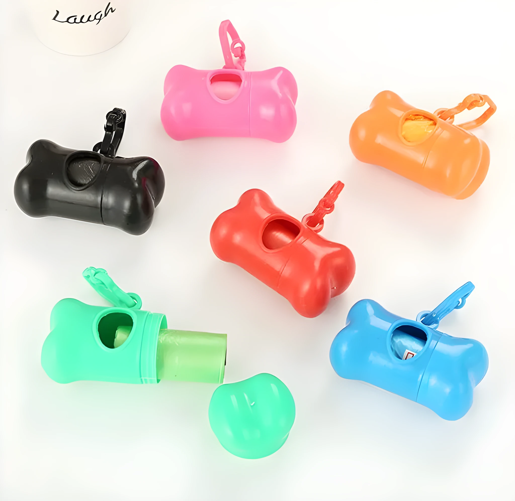 Bone-shaped pet garbage bag dispenser in new PP material, 8cm long and 5cm wide, on a table
