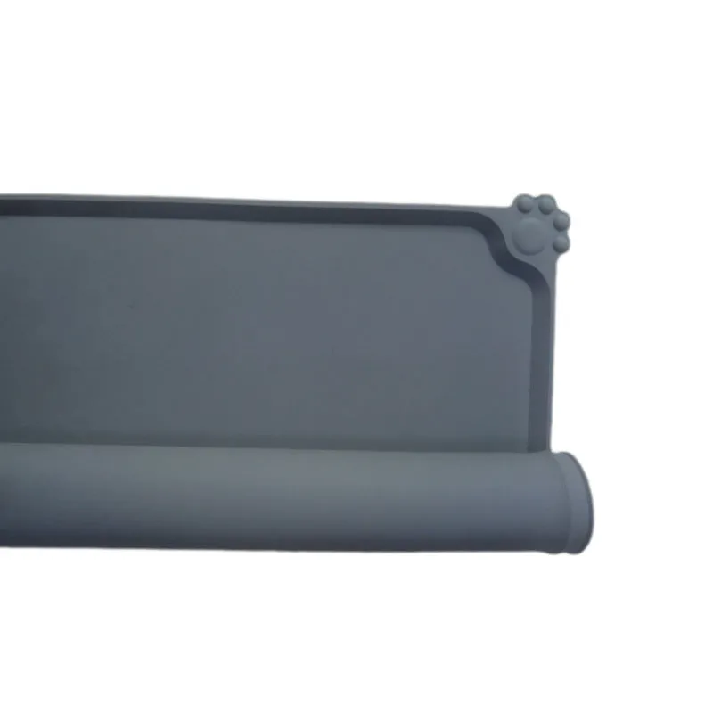 Grey waterproof silicone pet mat with raised edges and a non-slip base, measuring 47x29.5cm, placed under two pet bowls