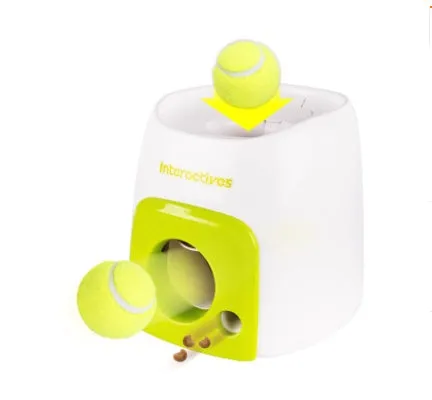 Smart pet feeder reward machine with two tennis balls and treat dispenser in green and white colour, shown on a wooden floor