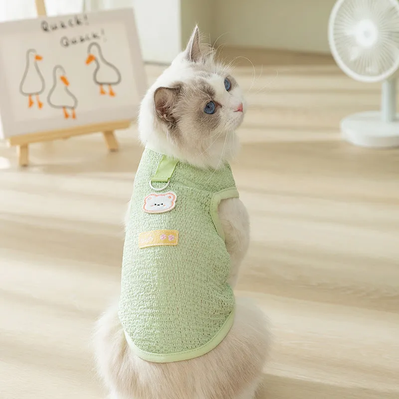 Cat wearing green bear patch cartoon clothing with hollowed-out breathable design
