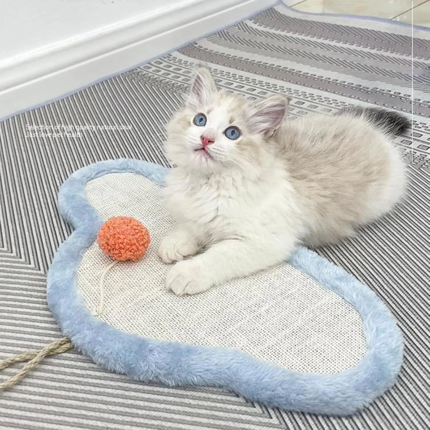 White wall-mounted cat scratching mat with sleeping cat cartoon design, made from natural sisal.