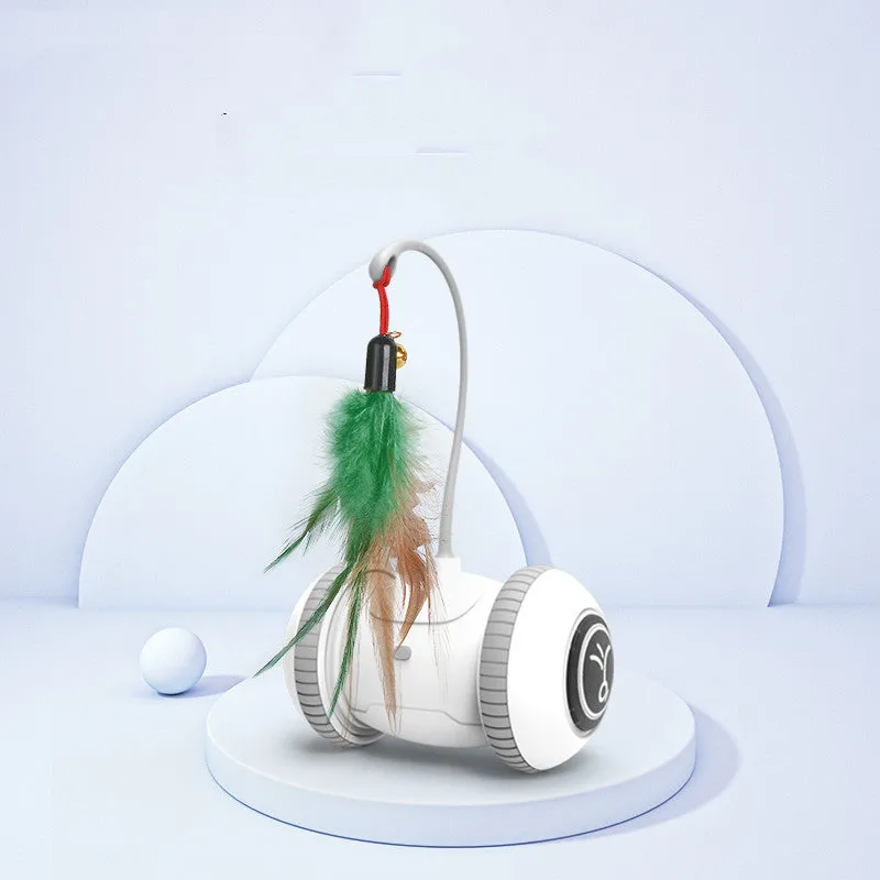 White and grey automatic interactive cat toy with interchangeable feather accessory on a floor, USB cable attached