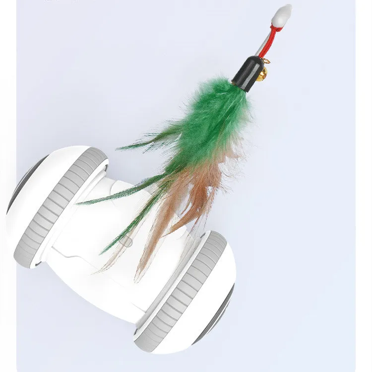 White and grey automatic interactive cat toy with interchangeable feather accessory on a floor, USB cable attached