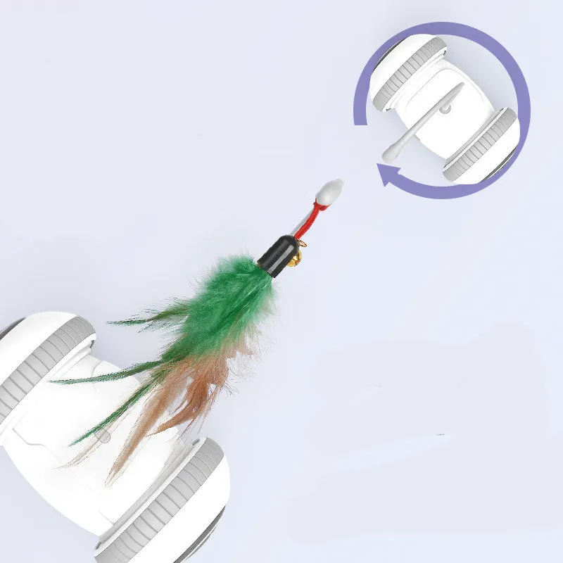 White and grey automatic interactive cat toy with interchangeable feather accessory on a floor, USB cable attached