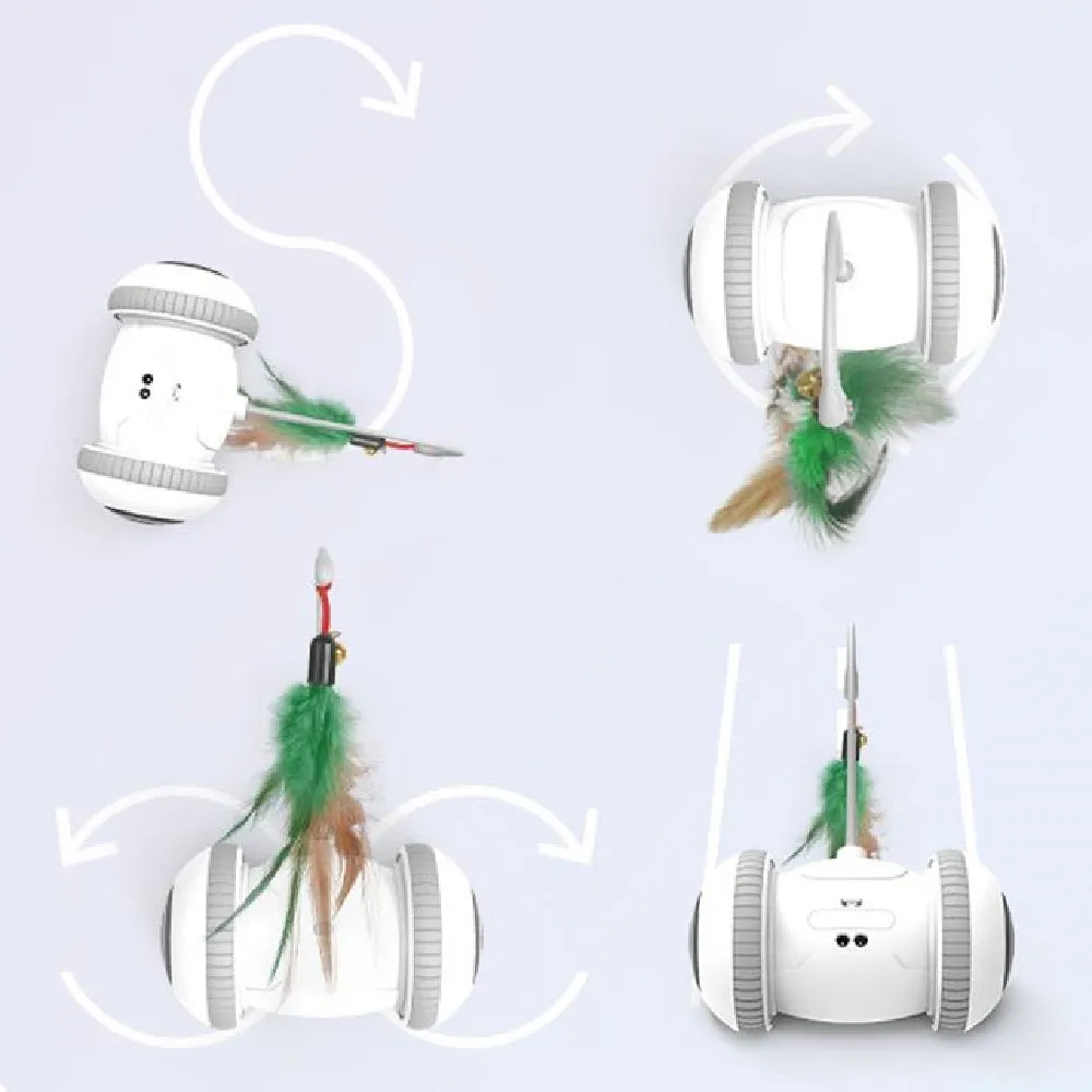 White and grey automatic interactive cat toy with interchangeable feather accessory on a floor, USB cable attached