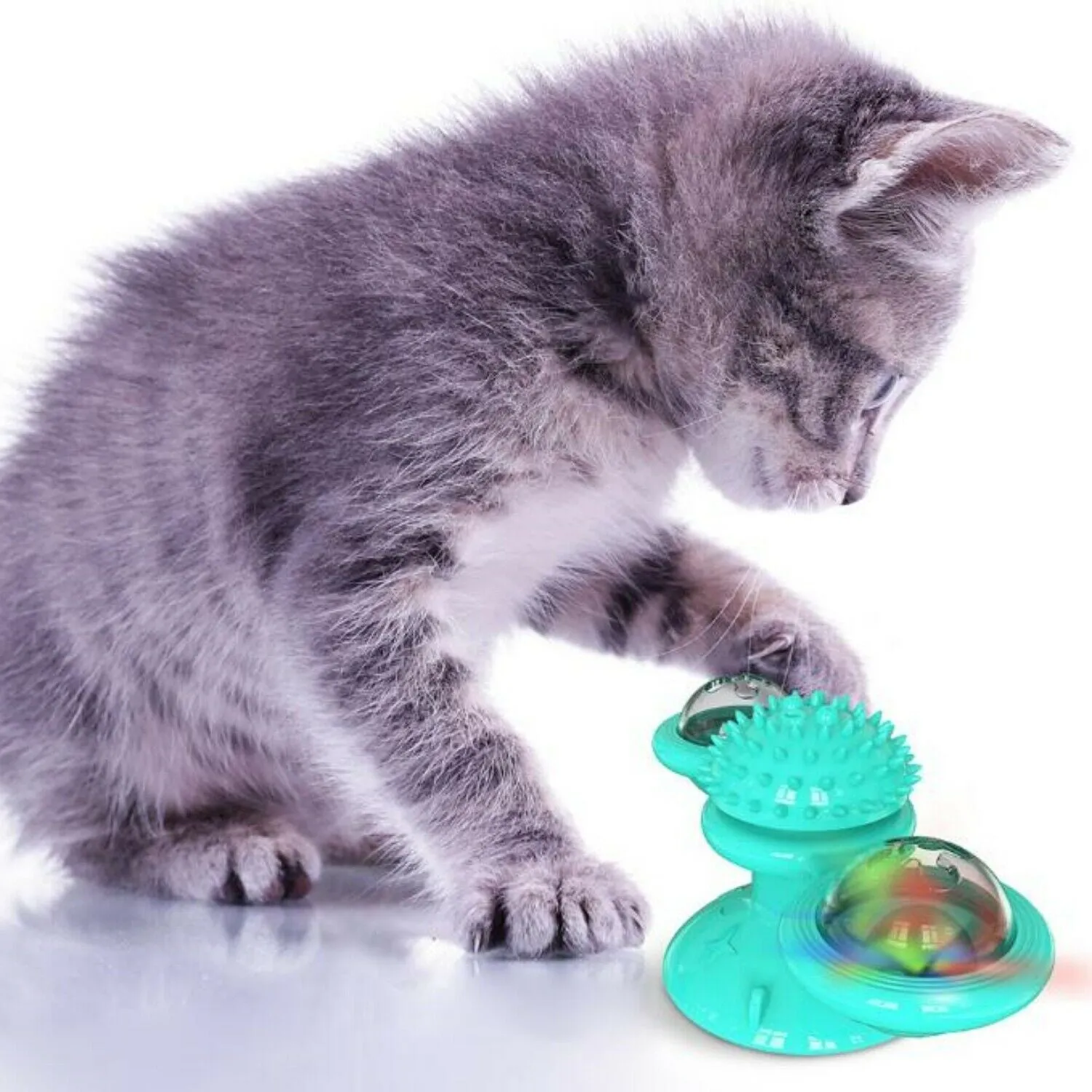 Rotating windmill cat toy with LED light and catnip balls on a white wall