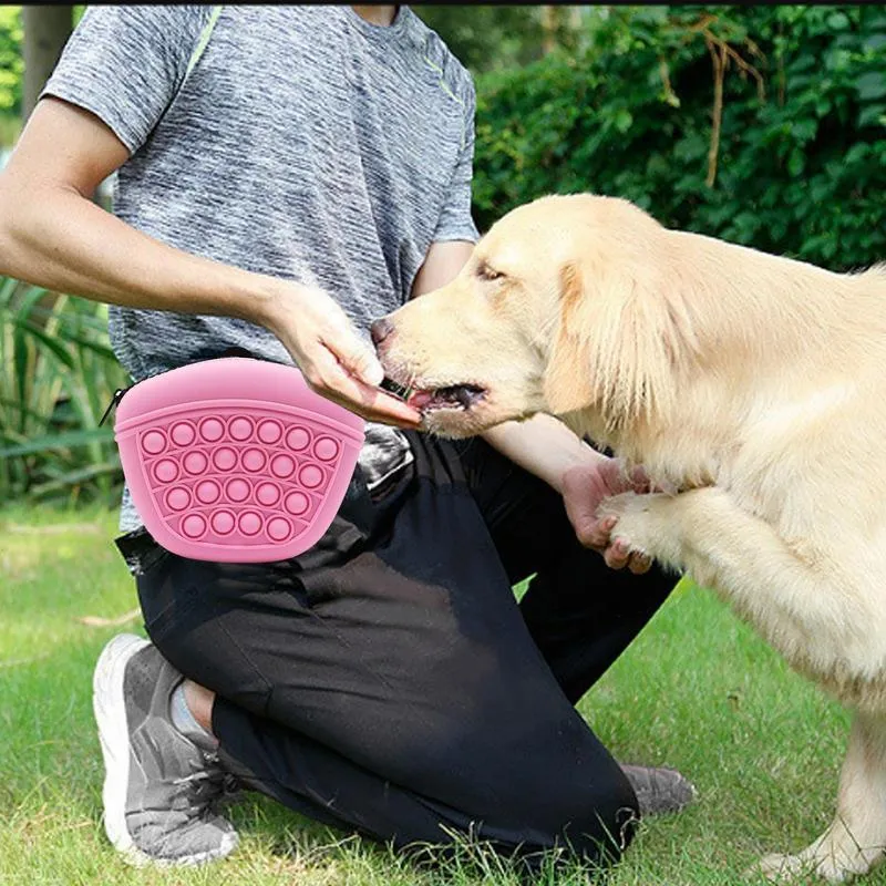 Blue silicone dog training treat pouch with magnetic closure and waist clip on a belt