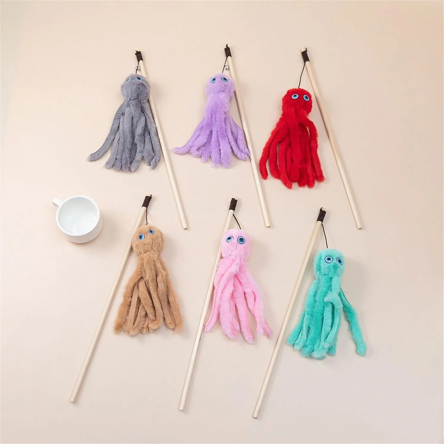 Octopus design cat toy with movable eyes on a long stick, shown in grey, pink, purple, or red.