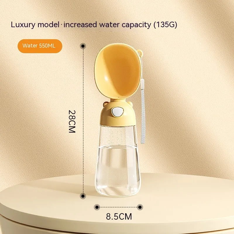 Portable dog water bottle and food container in yellow with attached bowl for outdoor pet hydration