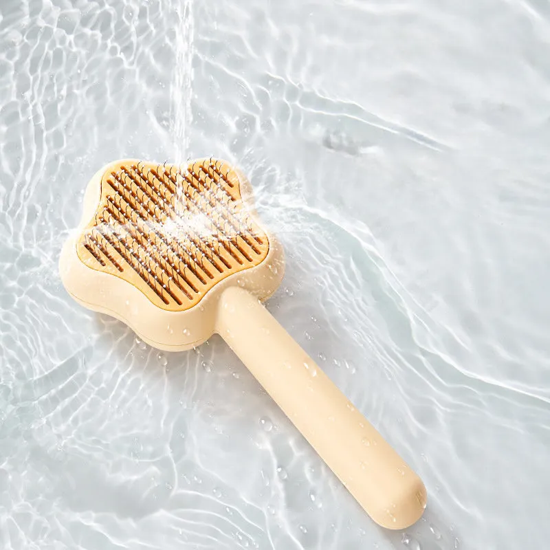 Self-cleaning stainless steel pet comb with green handle, showing the 20cm length and needle teeth
