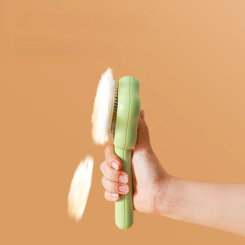 Self-cleaning stainless steel pet comb with green handle, showing the 20cm length and needle teeth