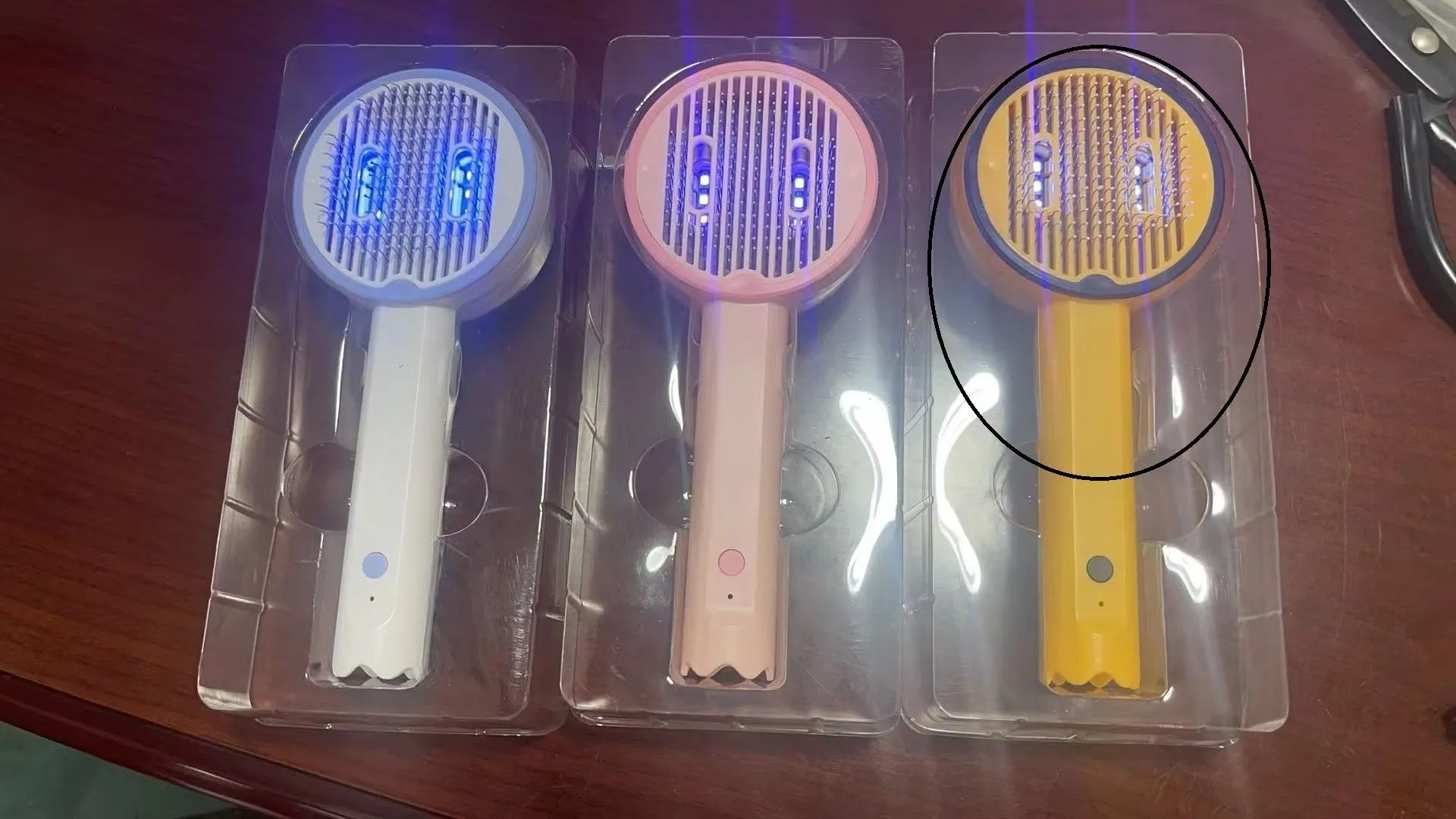 USB rechargeable UV sterilization pet comb for cats and dogs in pink, yellow, and white ABS plastic