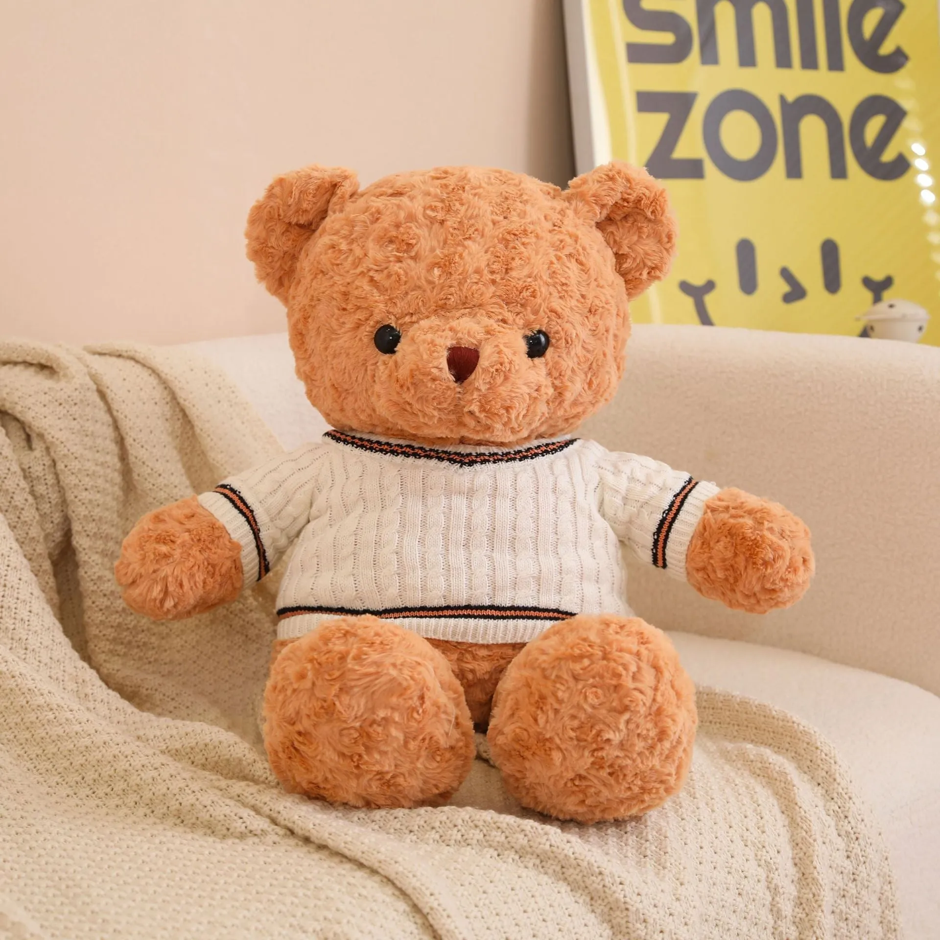 White sweater teddy bear plush toy with cloth velvet fabric and PP cotton filling, standing on a neutral background