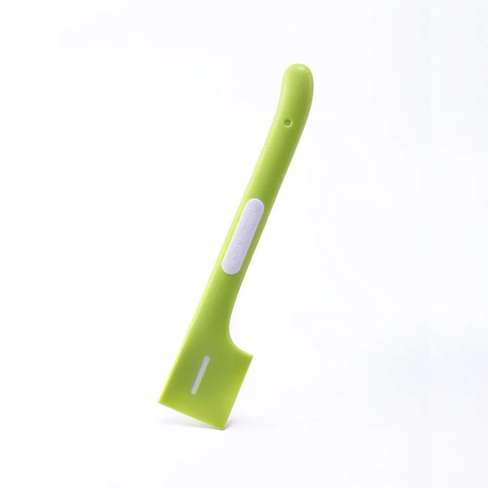 Green long-handled pet food spoon with angled head for scooping canned cat or dog food.