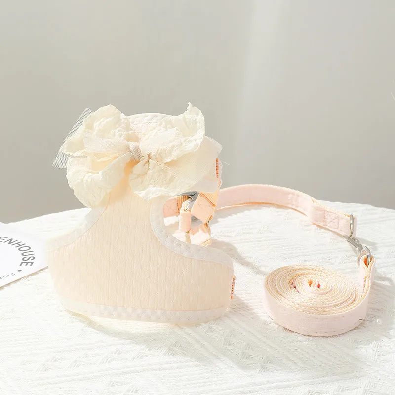 Small puppy hand-held rope chest strap in beige cloth on a wooden floor
