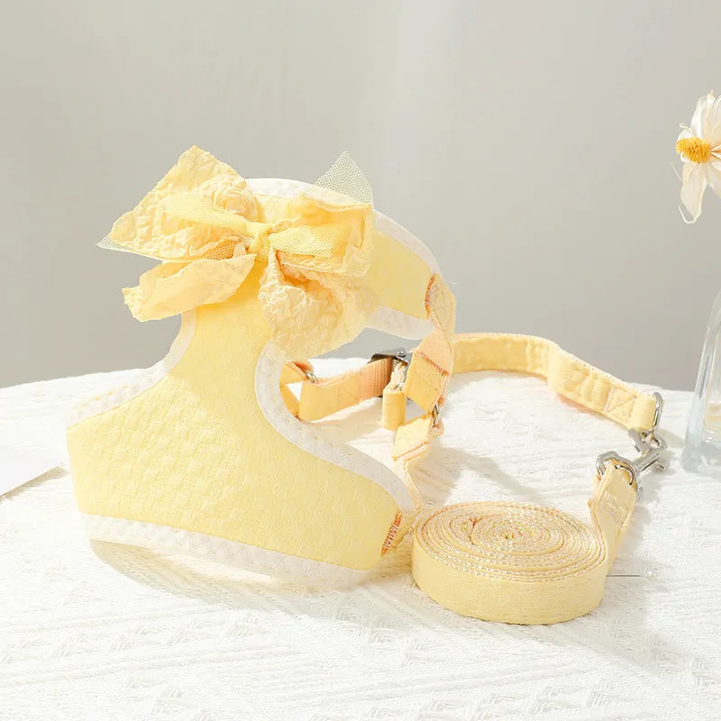Small puppy hand-held rope chest strap in beige cloth on a wooden floor