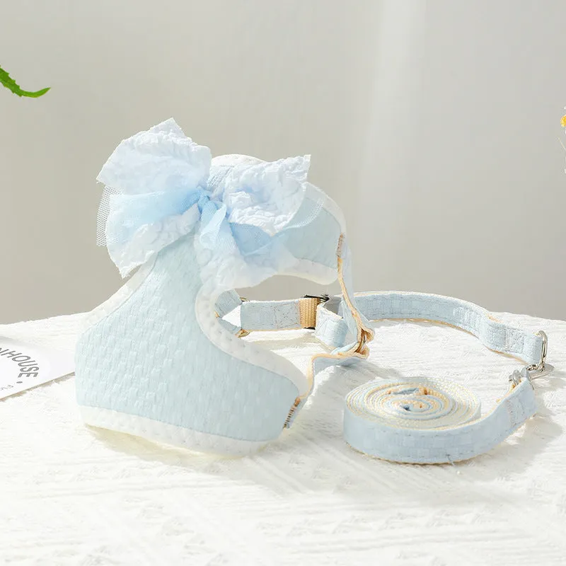 Small puppy hand-held rope chest strap in beige cloth on a wooden floor
