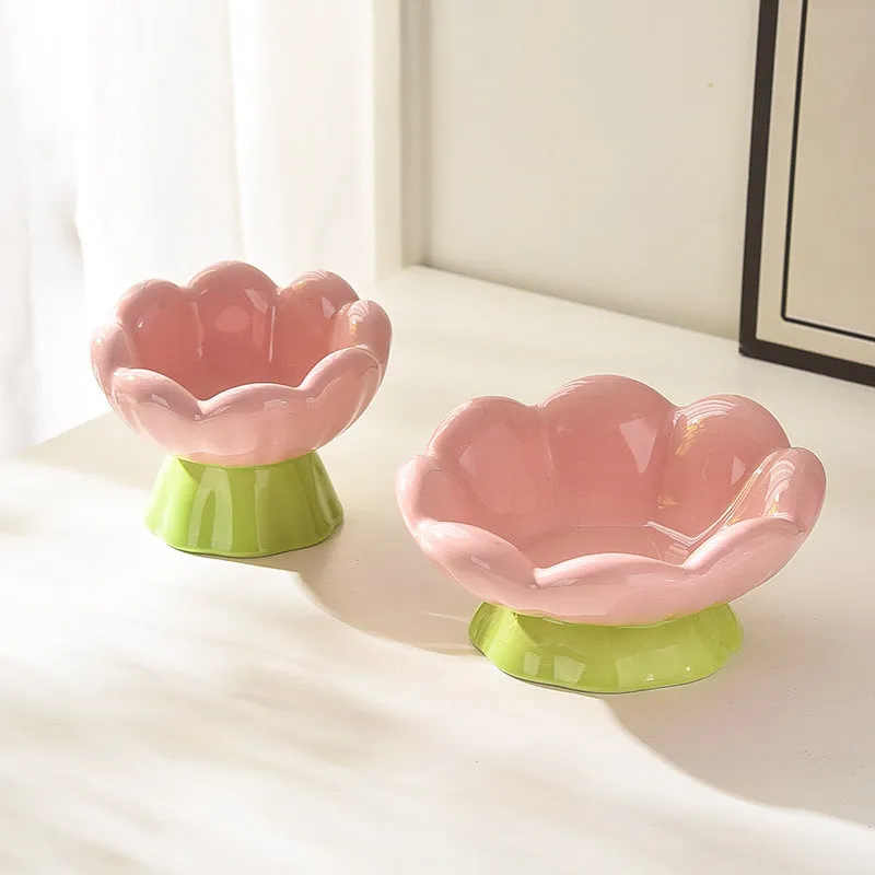 Pink ceramic raised cat bowl with wide shallow design, slanted angle, and flower shape on non-slip base