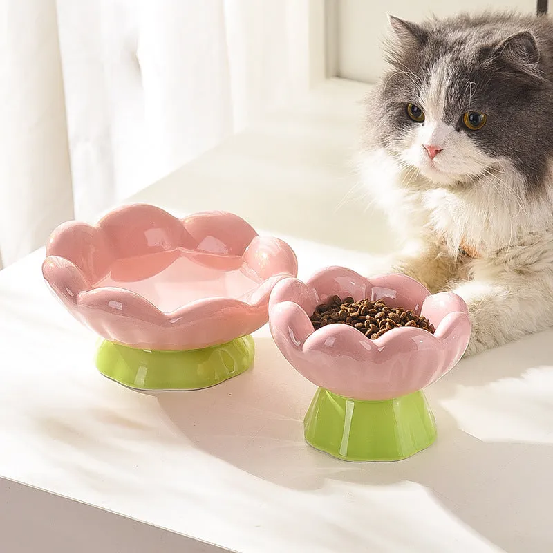 Pink ceramic raised cat bowl with wide shallow design, slanted angle, and flower shape on non-slip base