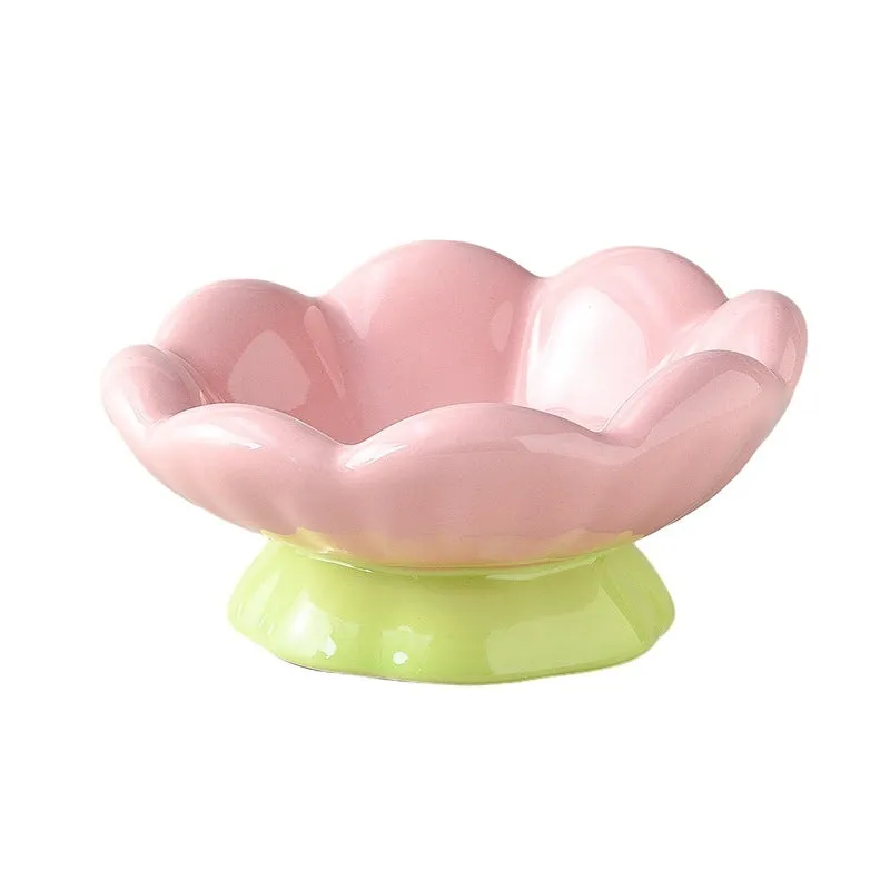 Pink ceramic raised cat bowl with wide shallow design, slanted angle, and flower shape on non-slip base