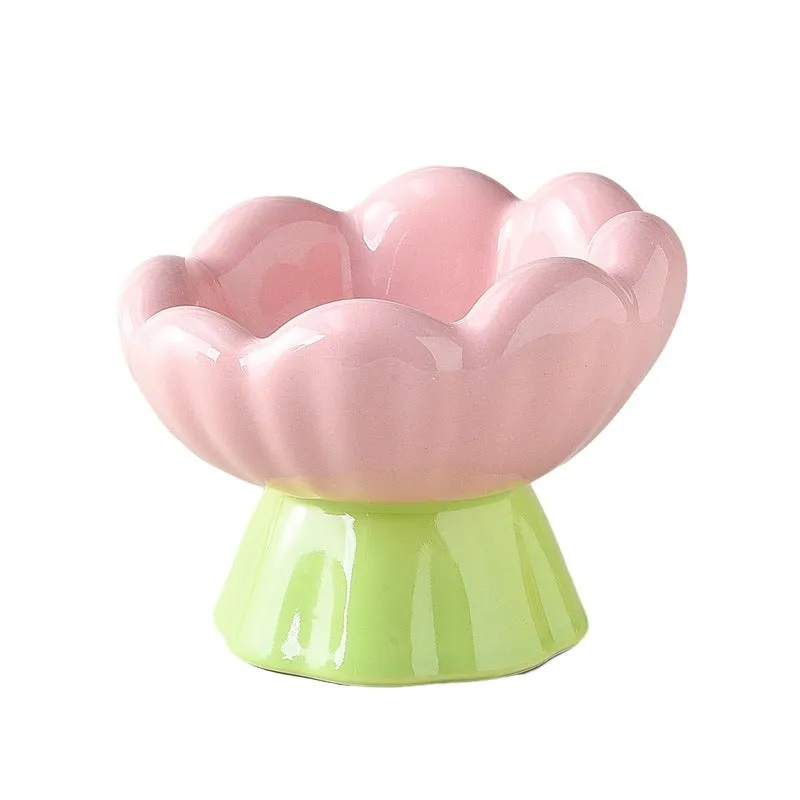 Pink ceramic raised cat bowl with wide shallow design, slanted angle, and flower shape on non-slip base