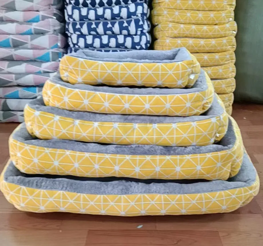 Moisture-proof linen dog bed in blue whale colour, rectangular shape with pillow, on floor.