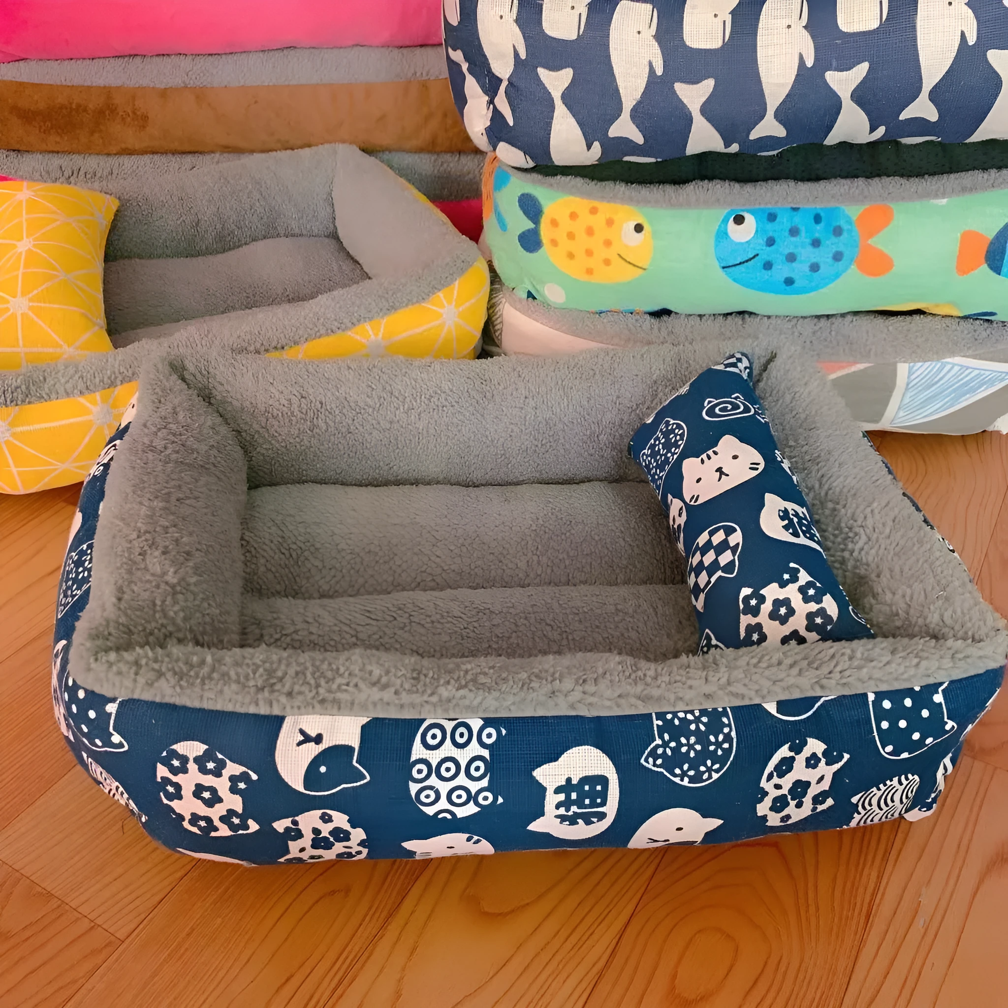 Moisture-proof linen dog bed in blue whale colour, rectangular shape with pillow, on floor.