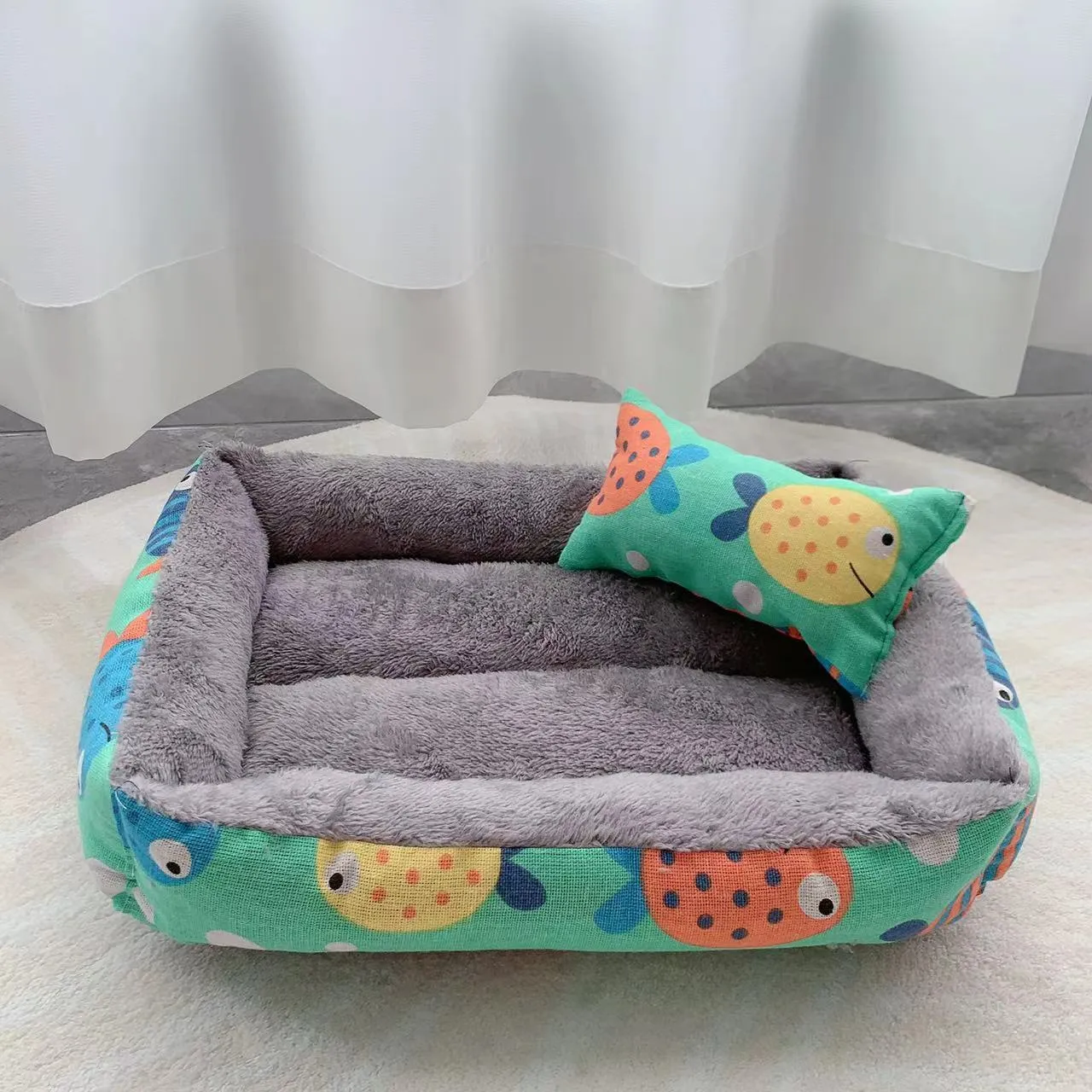 Moisture-proof linen dog bed in blue whale colour, rectangular shape with pillow, on floor.