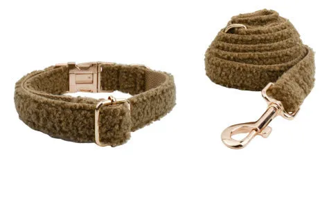 Brown polyester dog necklet set with collar, leash, bow, and vest on a hand-holding rope