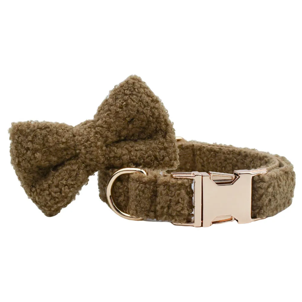 Brown polyester dog necklet set with collar, leash, bow, and vest on a hand-holding rope